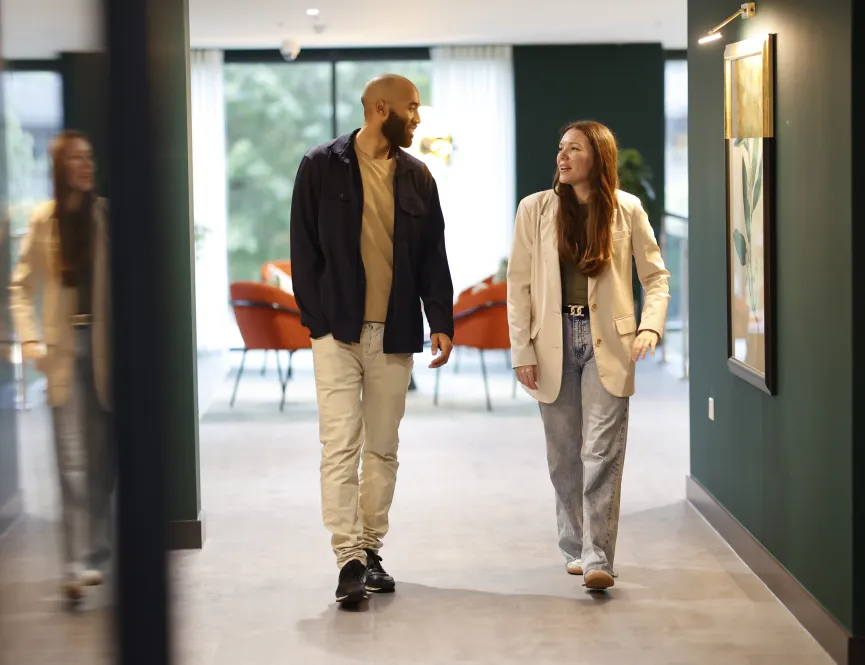 Man and women walking in a sales suite